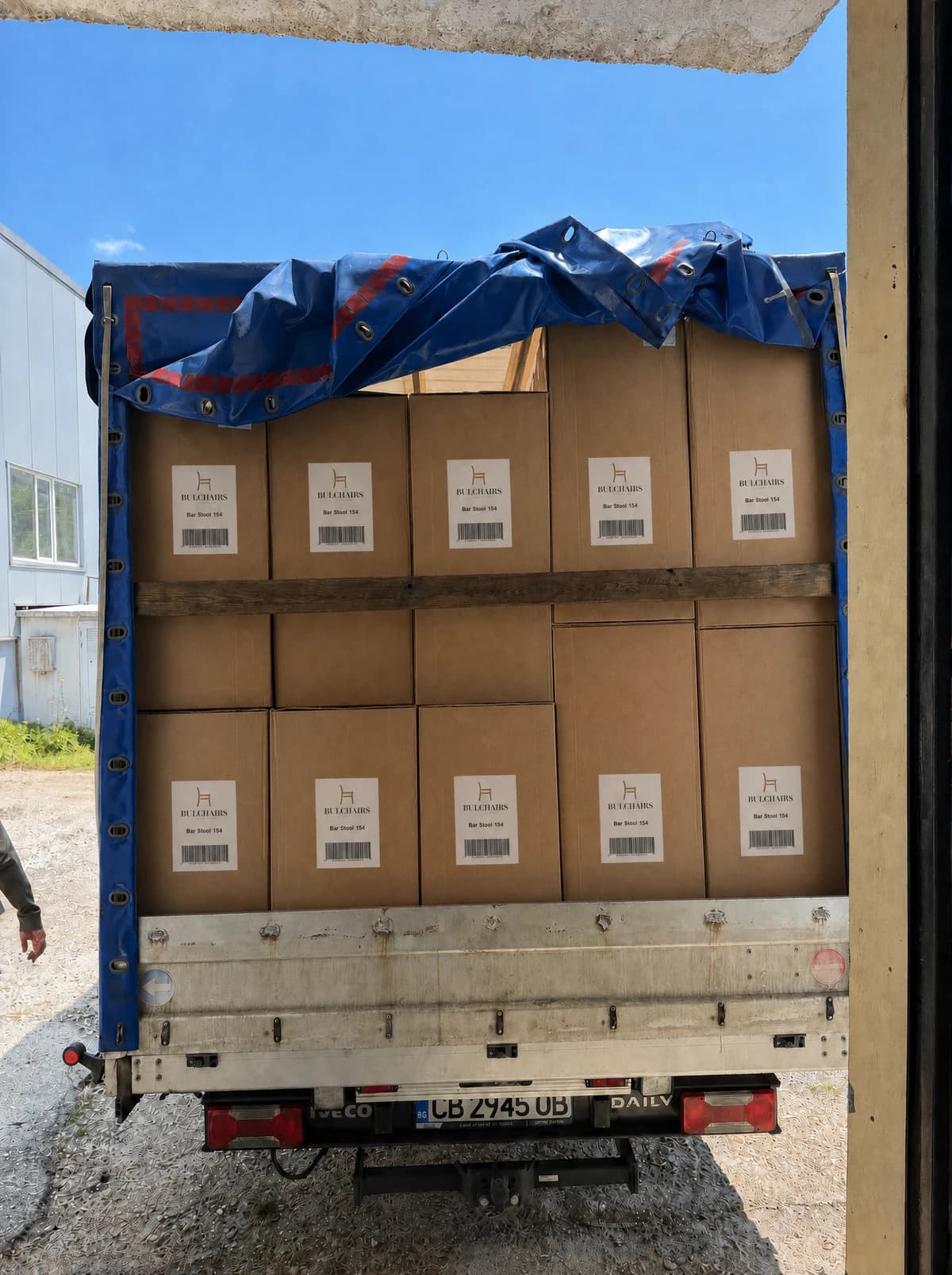 A van loaded with labelled BulChairs cartons, battened for the road